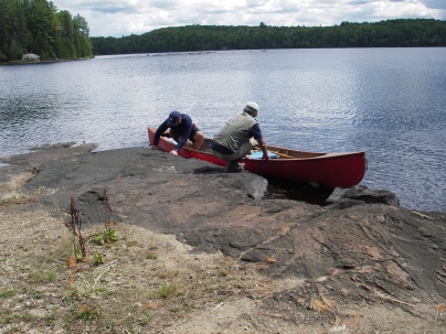Fritz and David get back in the canoe after exploring a rocky campsite.