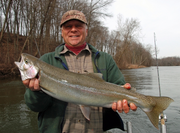 Captain Russ Clark hoists up a nice winter steelhead caught on the St. Joe River in February.